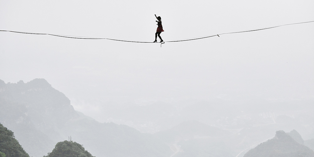 Salto-alto nas alturas: Mulheres participam de concurso de snackline de salto-alto em Zhangjiajie