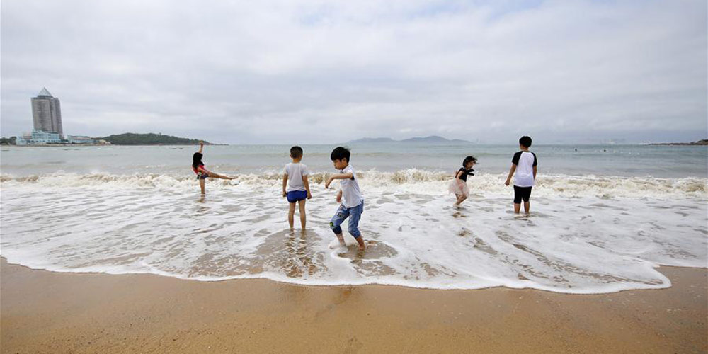Pessoas se divertem em balneários de Qingdao